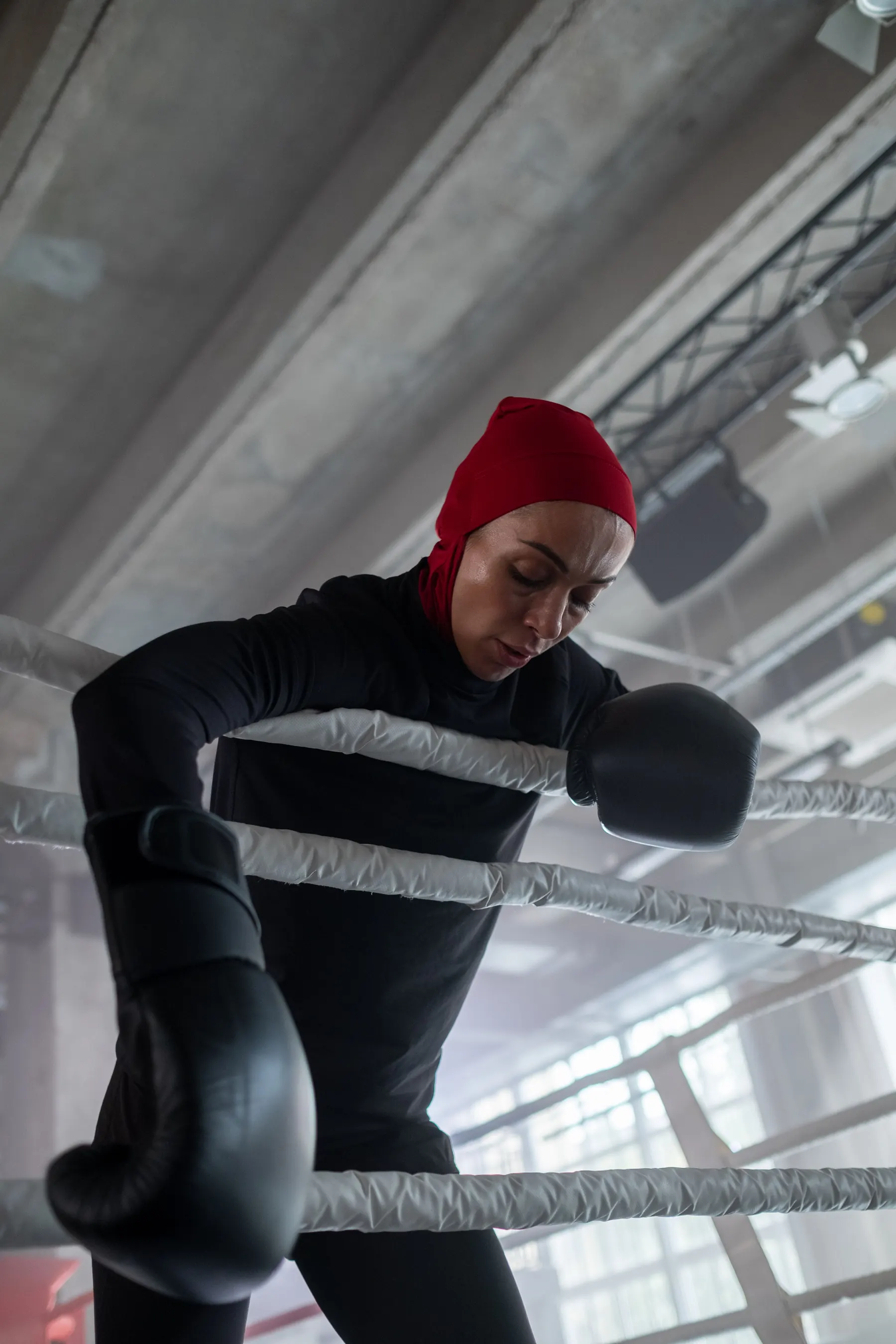 Female boxer wearing a hijab training with gloves